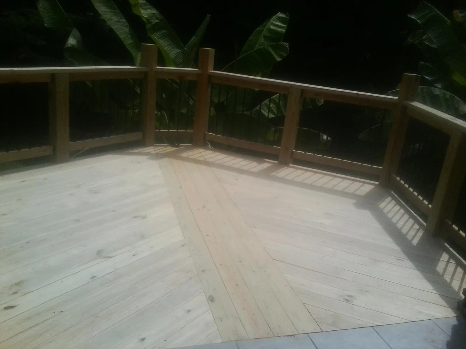 New wood deck and railing built off the back of a home in Geneva
